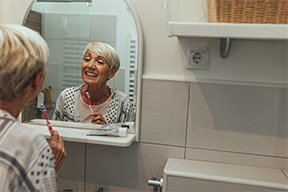 Dentures patient in Arlington brushing