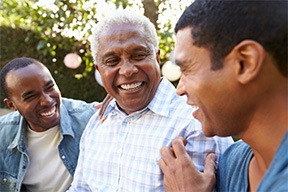 Dentures patient in Arlington smiling with family