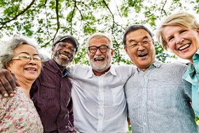 Dentures patient in Arlington talking with friends