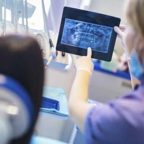 Dentist and dental patient looking at digital x rays